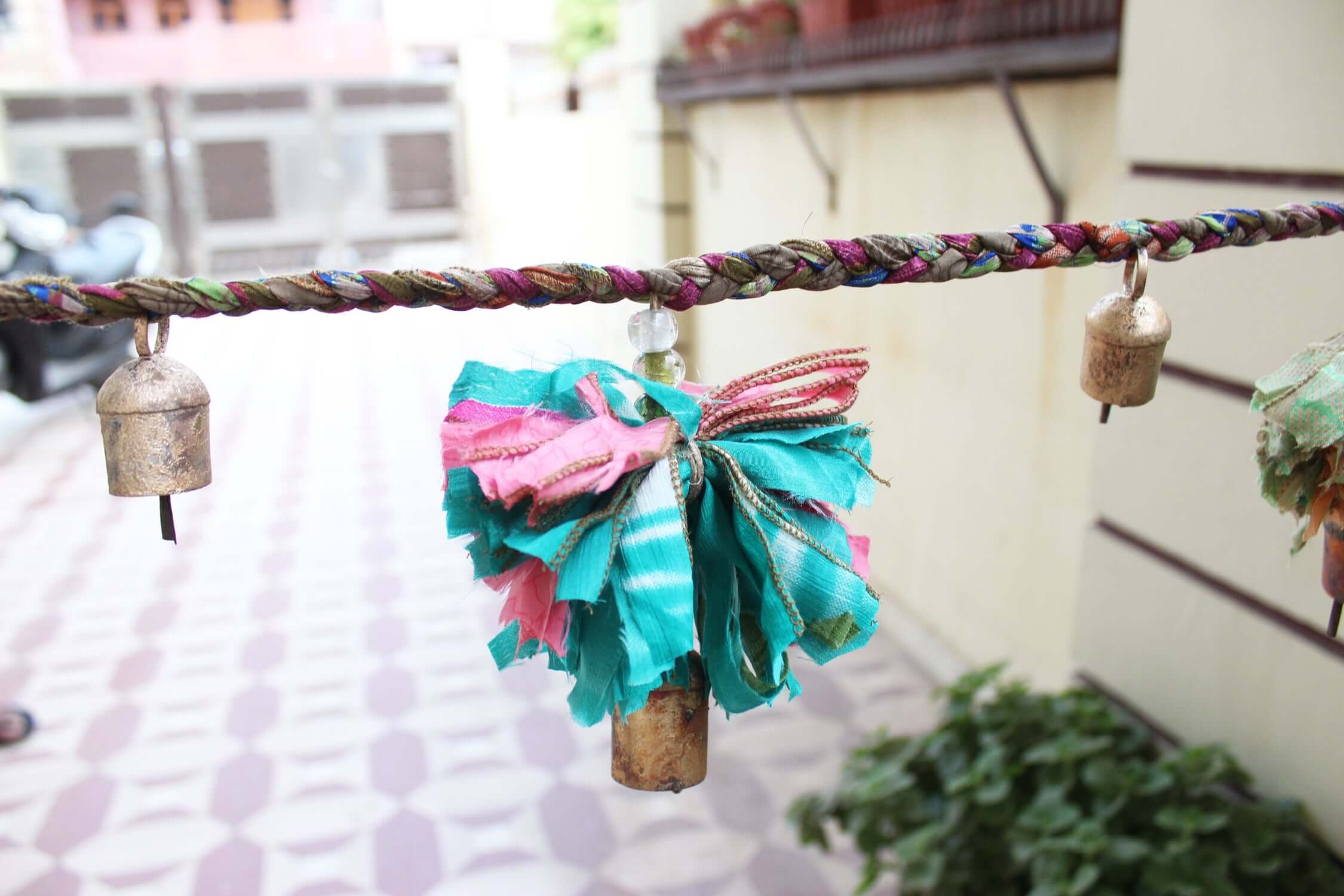 Adorn your space with this 5ft handmade garland of brass bells and glass beads. Perfect for parties and home decoration.