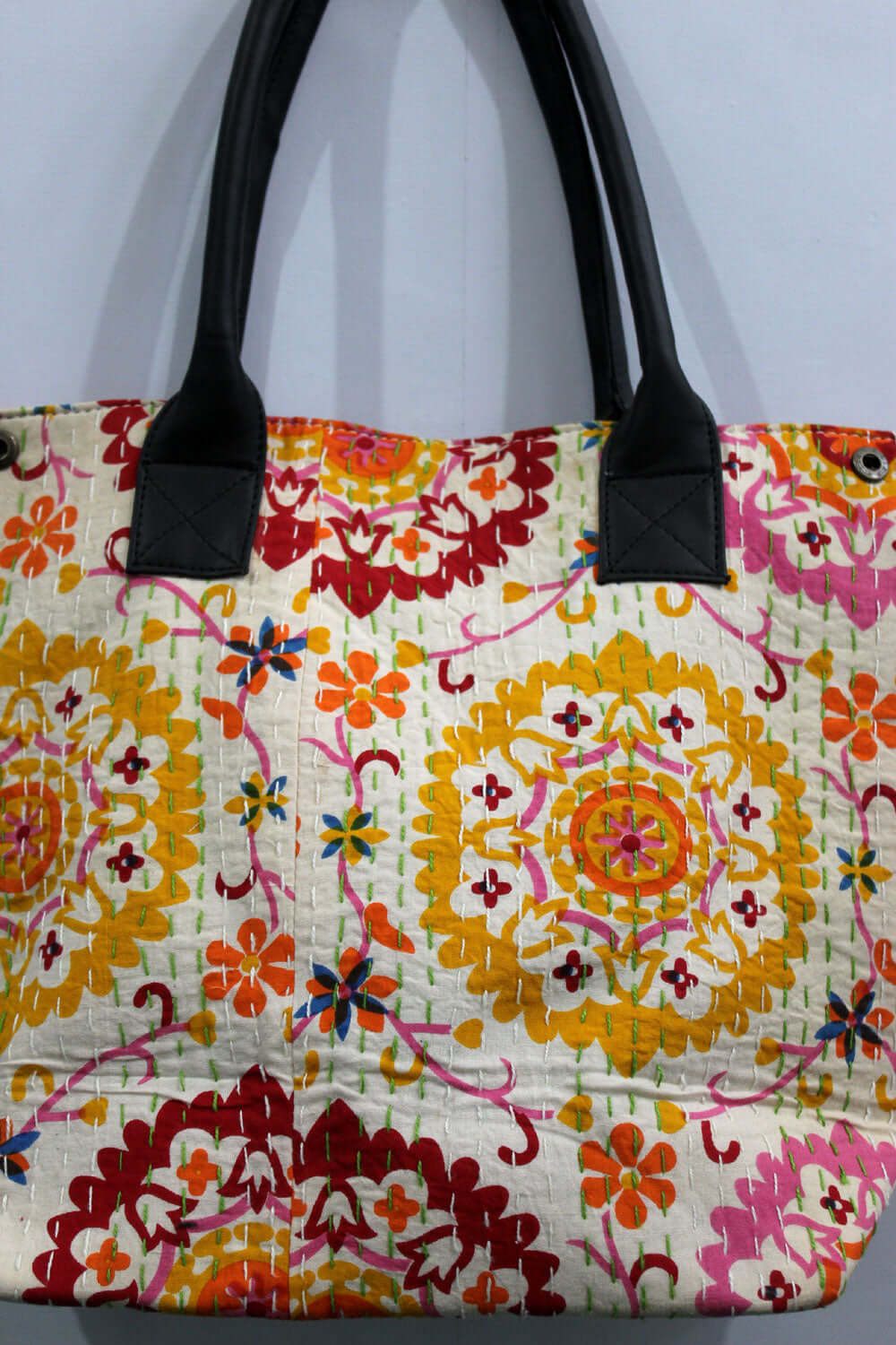 Chakra design handmade cotton tote bag with leather straps, featuring vibrant floral patterns and a spacious interior.