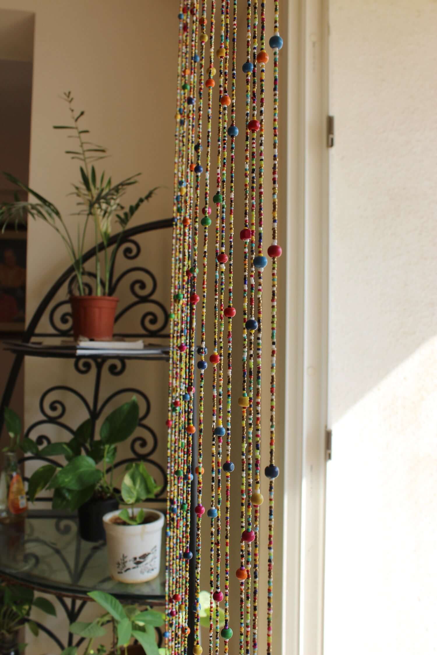 Colorful Bohemian beaded doorway garland with jingle bells, adding vibrant charm to home decor.