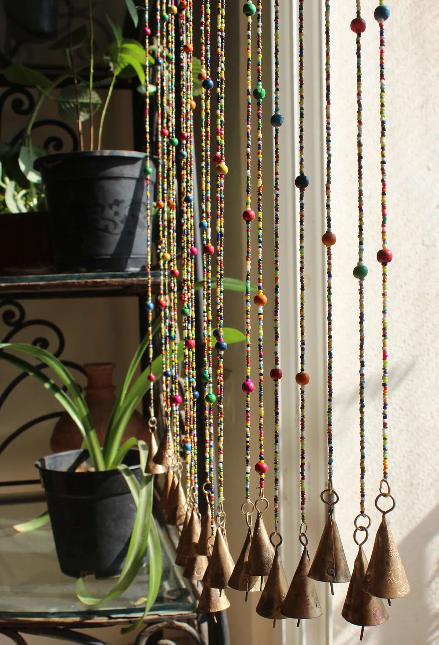 Colorful Bohemian beaded doorway garland with jingle bells, adding vibrant decor to any home.