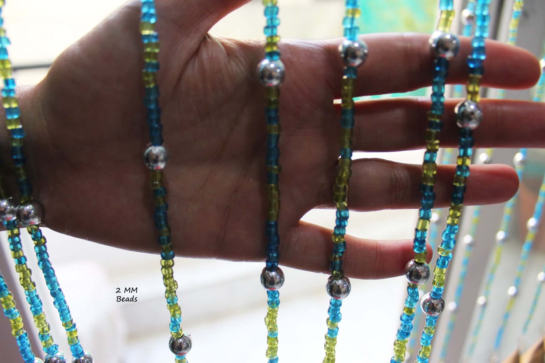 Handmade colorful glass bead strands with jingle bells—perfect for doorways or wall décor. Eco-friendly and crafted by women's artisans in India.