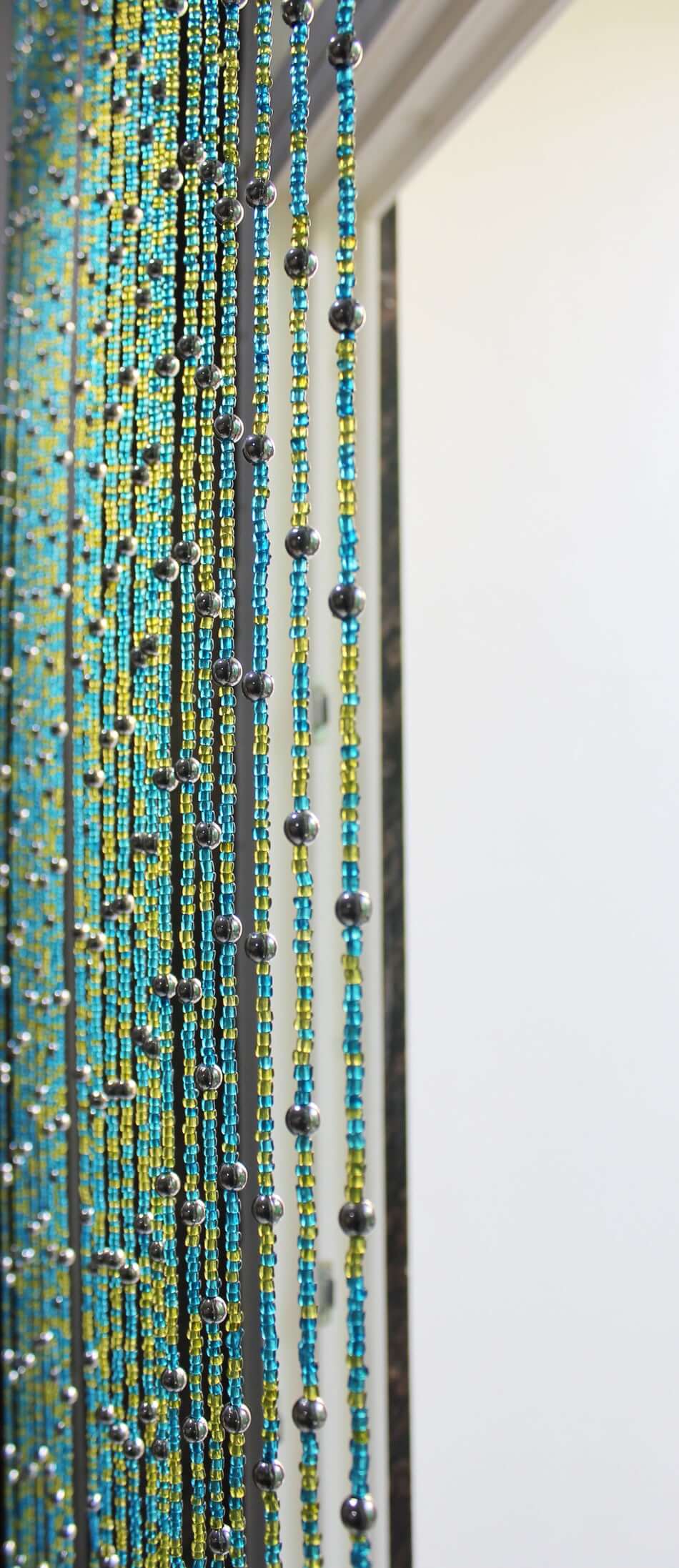 Handmade colorful glass bead strands with jingle bells—perfect for doorways or wall décor. Eco-friendly and crafted by women's artisans in India.