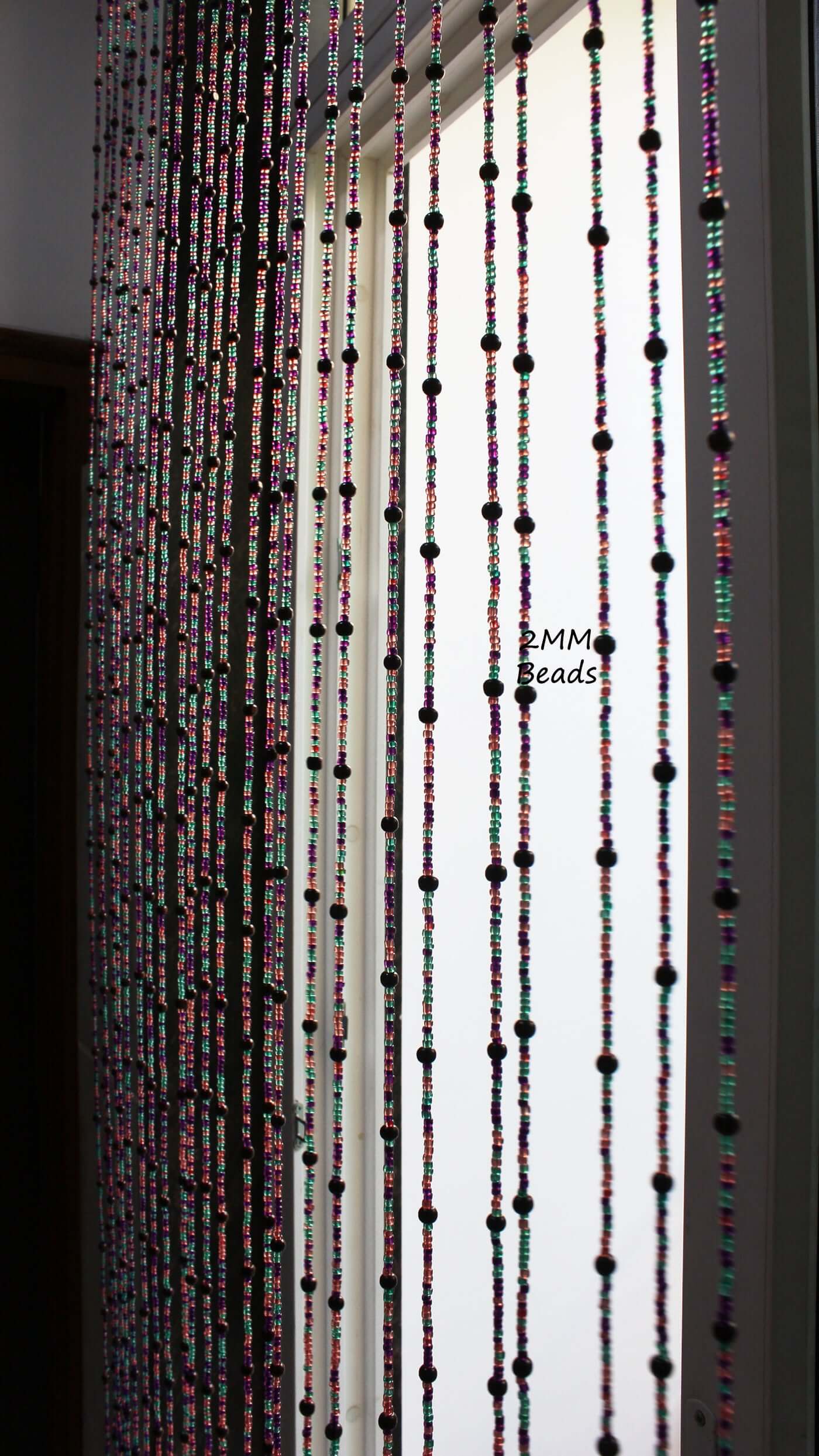 Handmade colorful glass bead strands with jingle bells—perfect for doorways or wall décor. Eco-friendly and crafted by women's artisans in India.