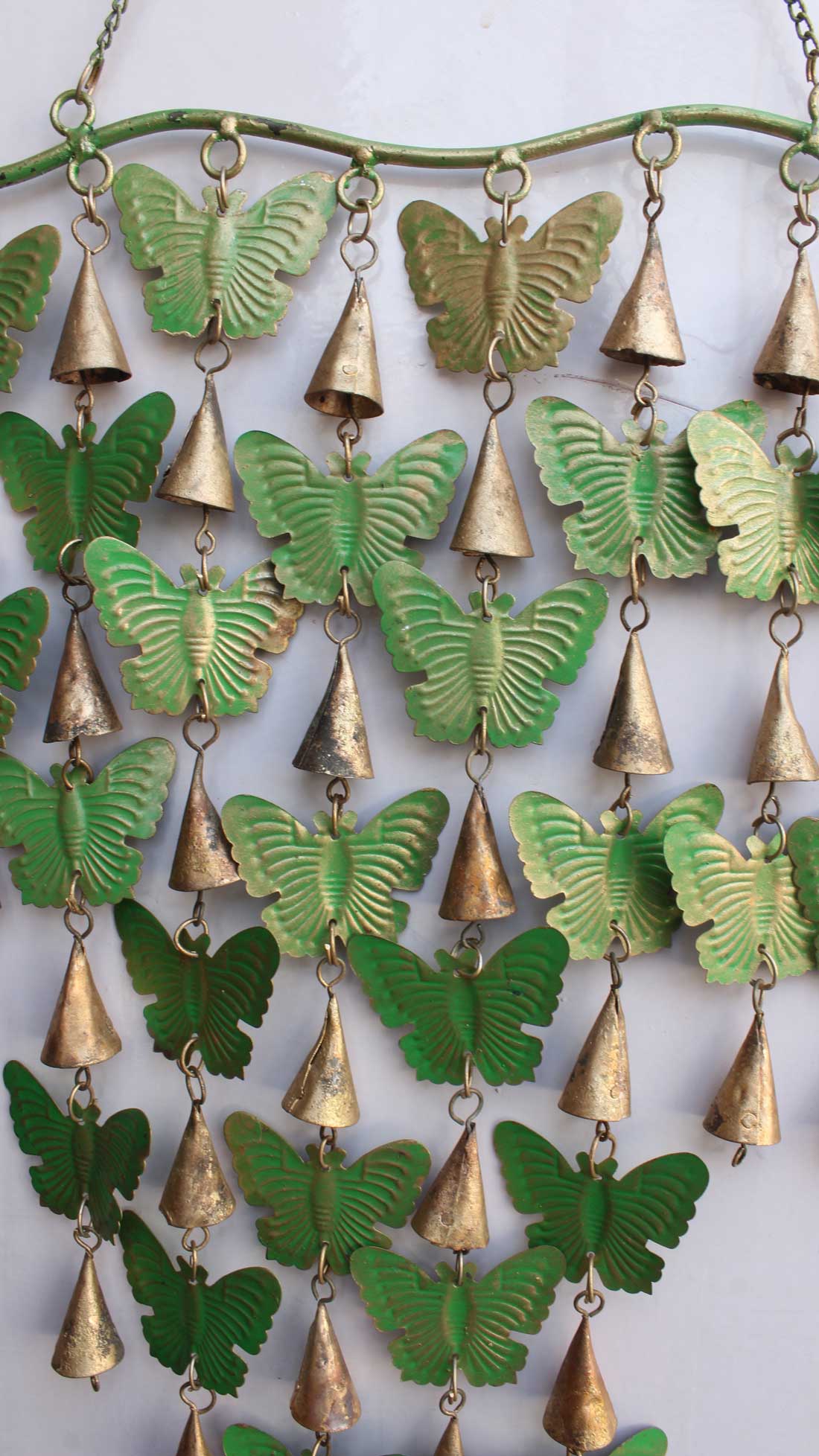 Enhance your space with this green 28 butterflies wind chime, perfect for indoor and outdoor decoration. Tinkling bells create a soothing ambiance.