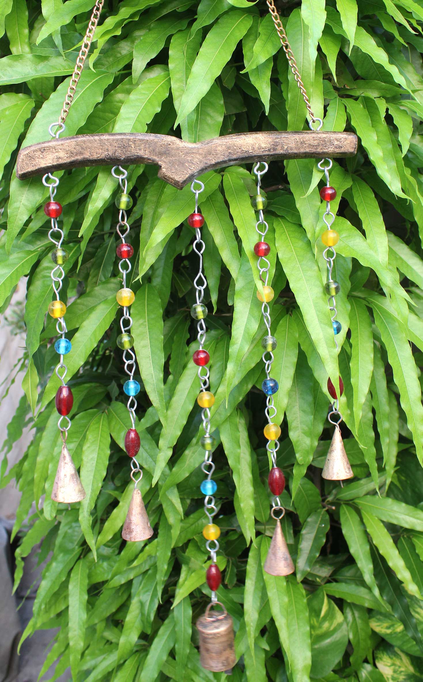 Handmade boho wind chime with colorful glass beads and metal bells, perfect for home decoration.