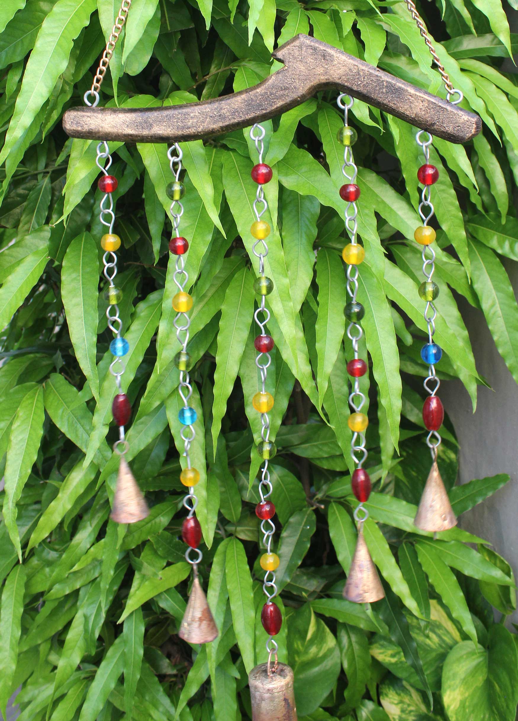 Handmade beaded wind chime featuring vibrant colors and metal bells, ideal for boho decor and suncatchers.