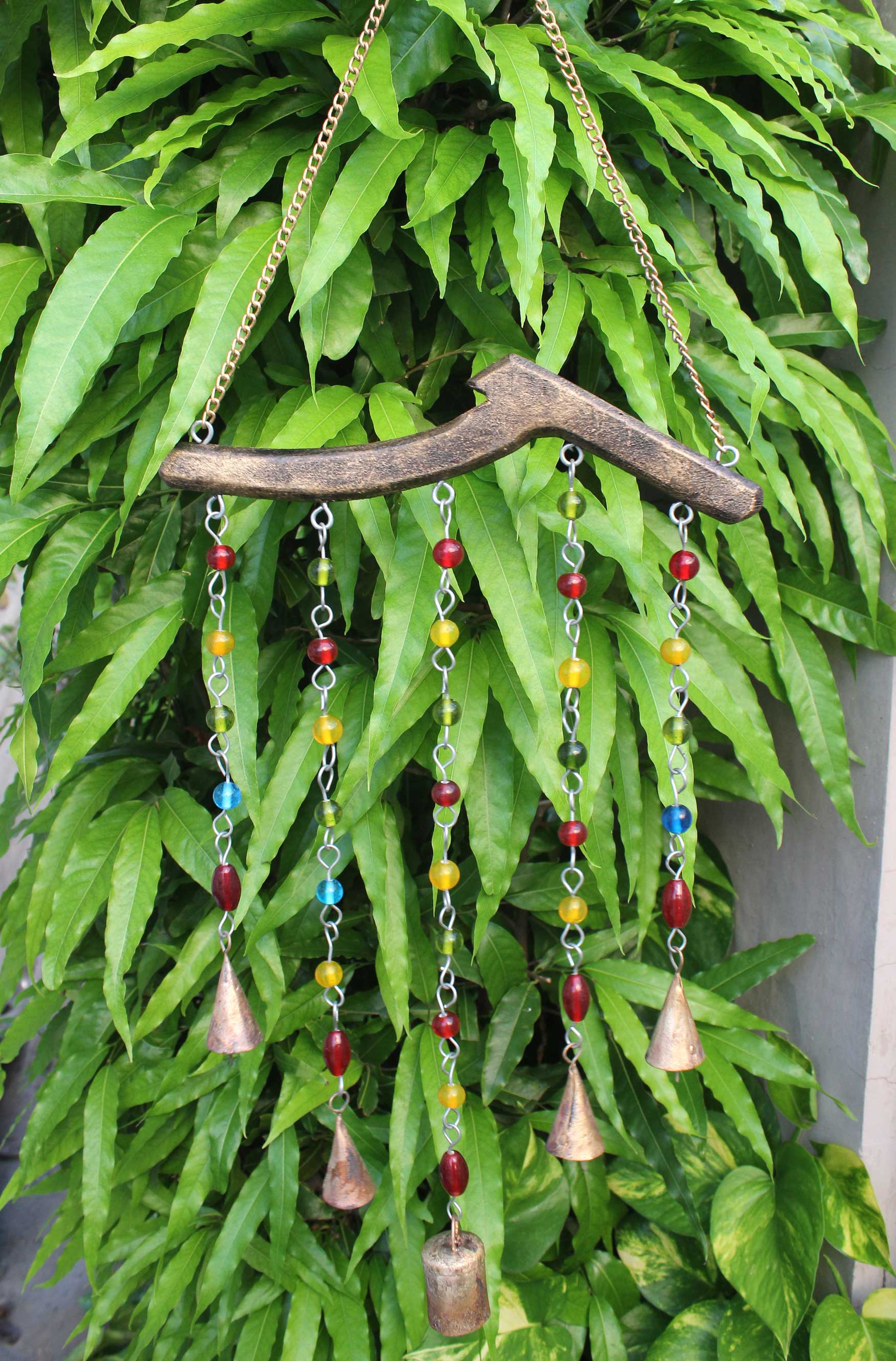 Handmade bohemian hanging chime bells and beads decoration, perfect for garden and patio, crafted in India.