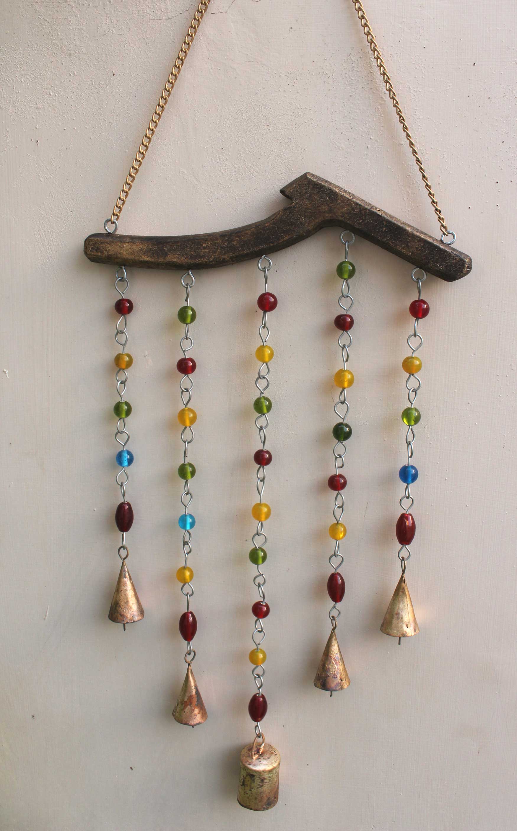 Handmade beaded iron wind chime featuring colorful glass beads and metal bells, perfect for boho decor.