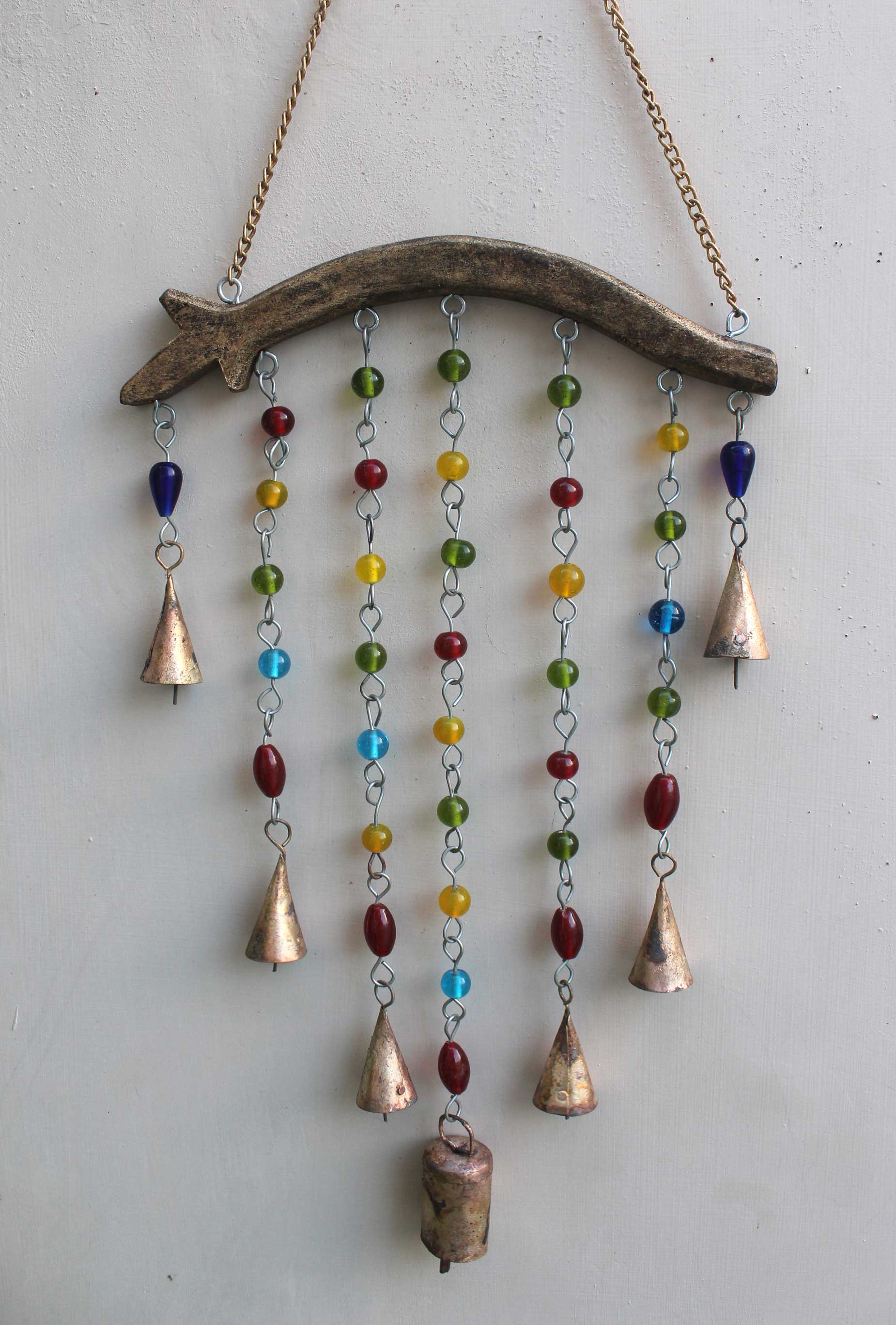 Handmade beaded wind chime with metal bells and colorful glass beads in a bohemian design, ideal for home decor.