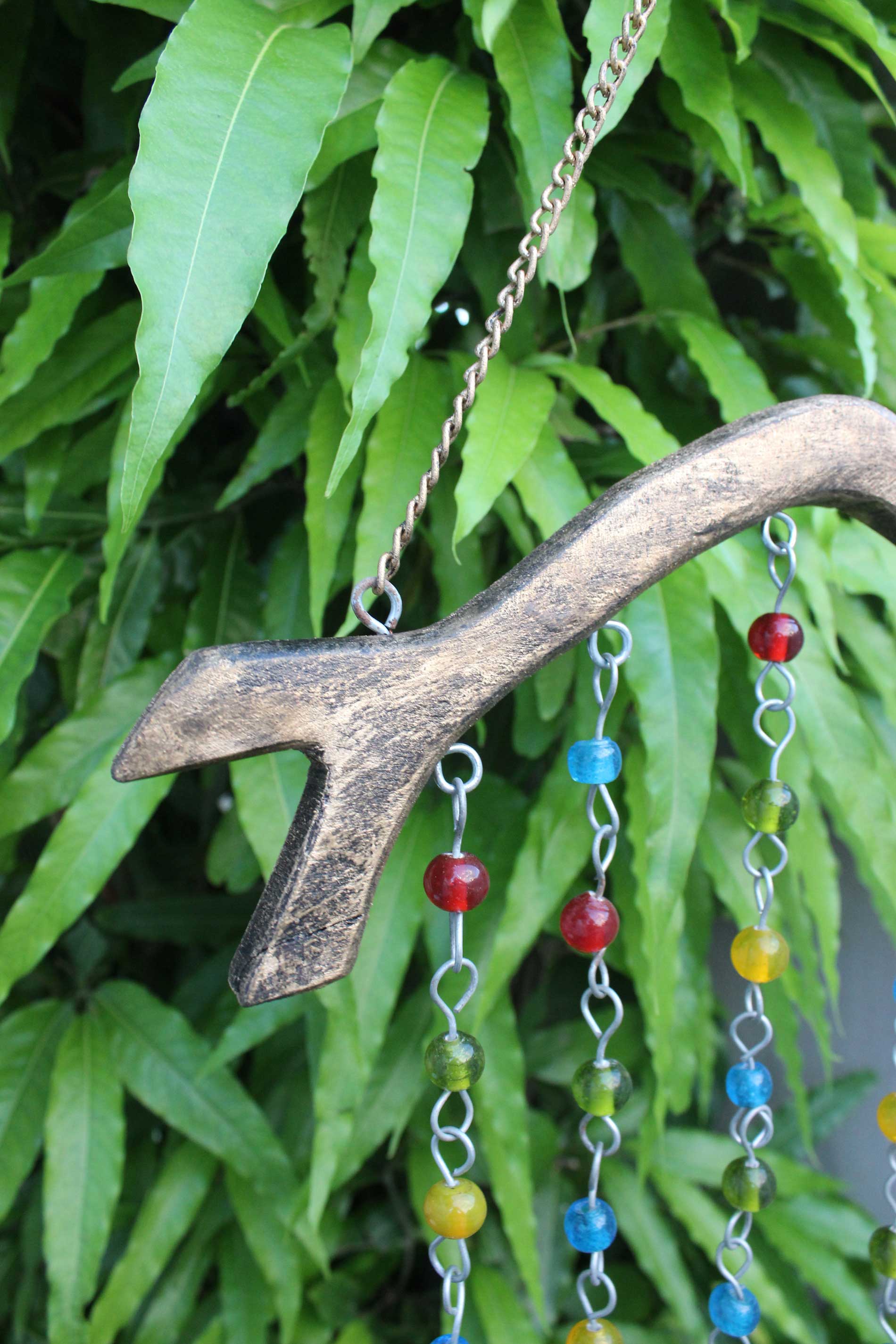 Handmade beaded iron wind chime with colorful glass beads and wood, perfect for boho decor and suncatching.