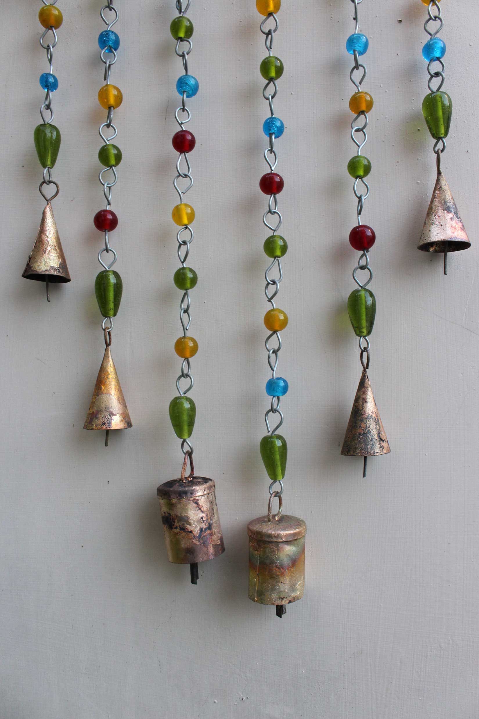 Handmade Bohemian sun catcher with colorful beads and tin bells, ideal for garden or indoor decoration.