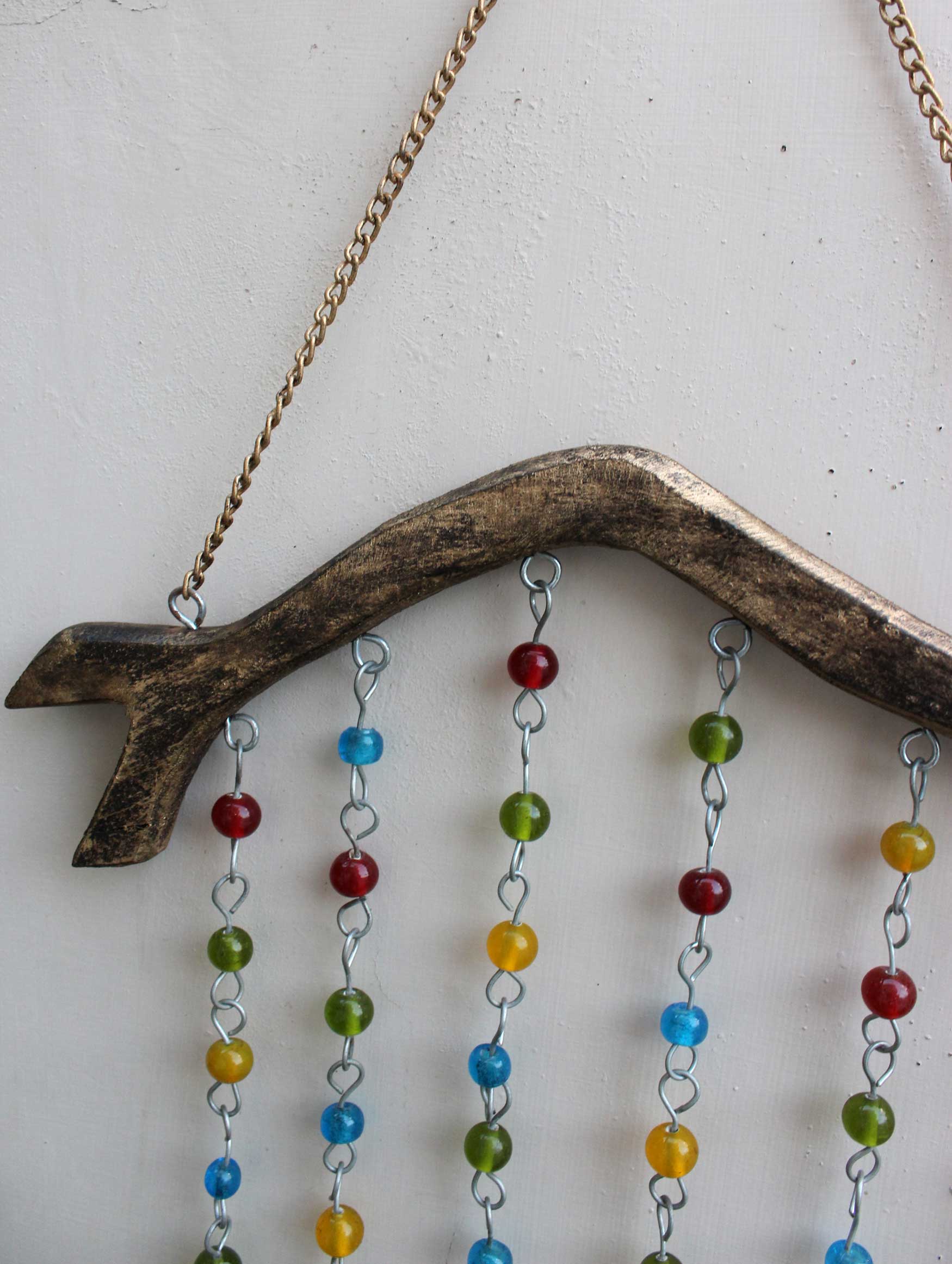 Handmade hanging chime with colorful beads and tin bells, perfect for garden or indoor decoration.