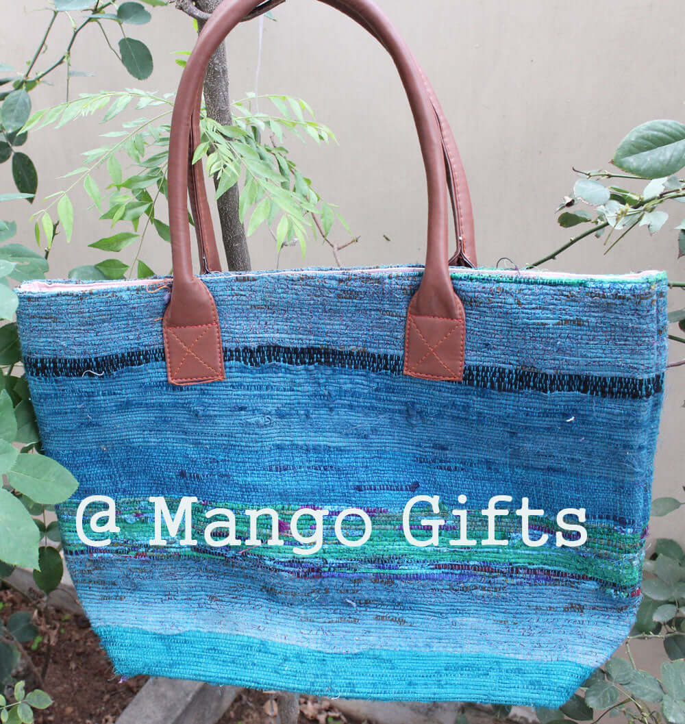 Handmade Chindi rug tote bag in blue, featuring leather handles, ideal for stylish errands and eco-friendly fashion.