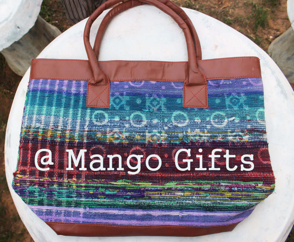 Chindi rug tote bag with multi-colored cotton design and leather straps, ideal for shopping and picnics.