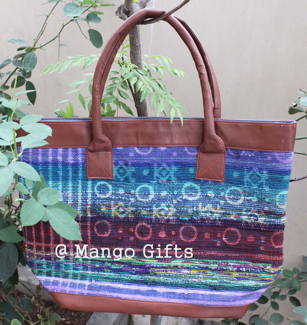 Chindi rug tote bag with leather straps, colorful cotton design, perfect for shopping or picnics, handmade in India.