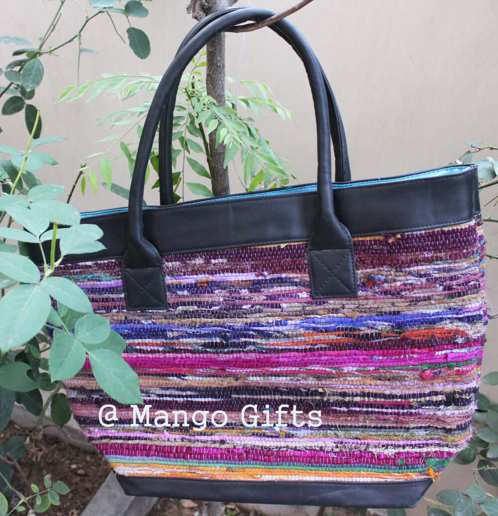 Colorful Chindi Rug tote bag with leather straps, perfect for shopping and picnics, handmade in India.