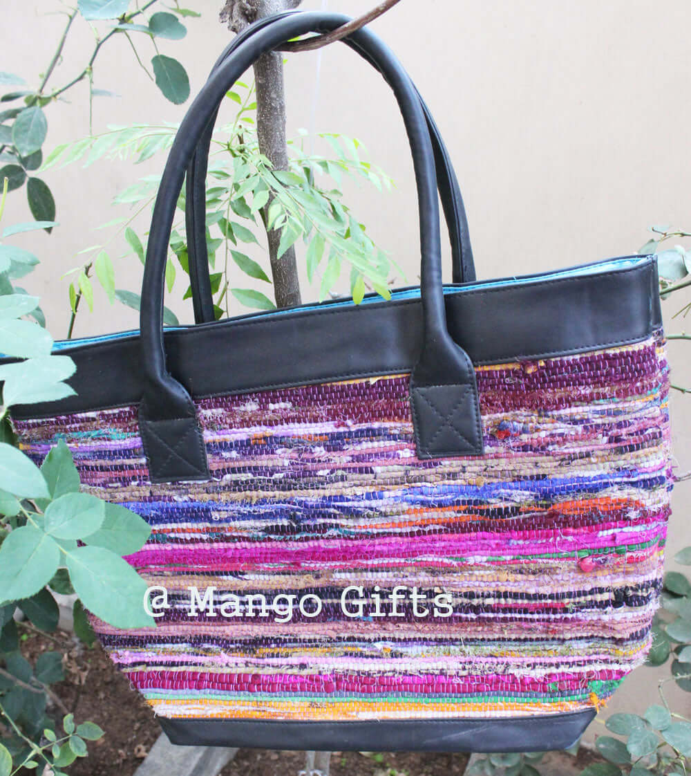 Colorful Chindi rug tote bag with leather straps, perfect for shopping or picnics, handmade in India.