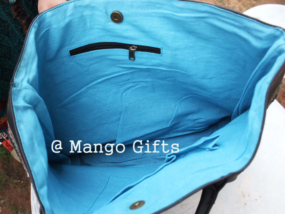 Interior view of the stylish green cotton Kantha bag showcasing vibrant blue lining and pockets.