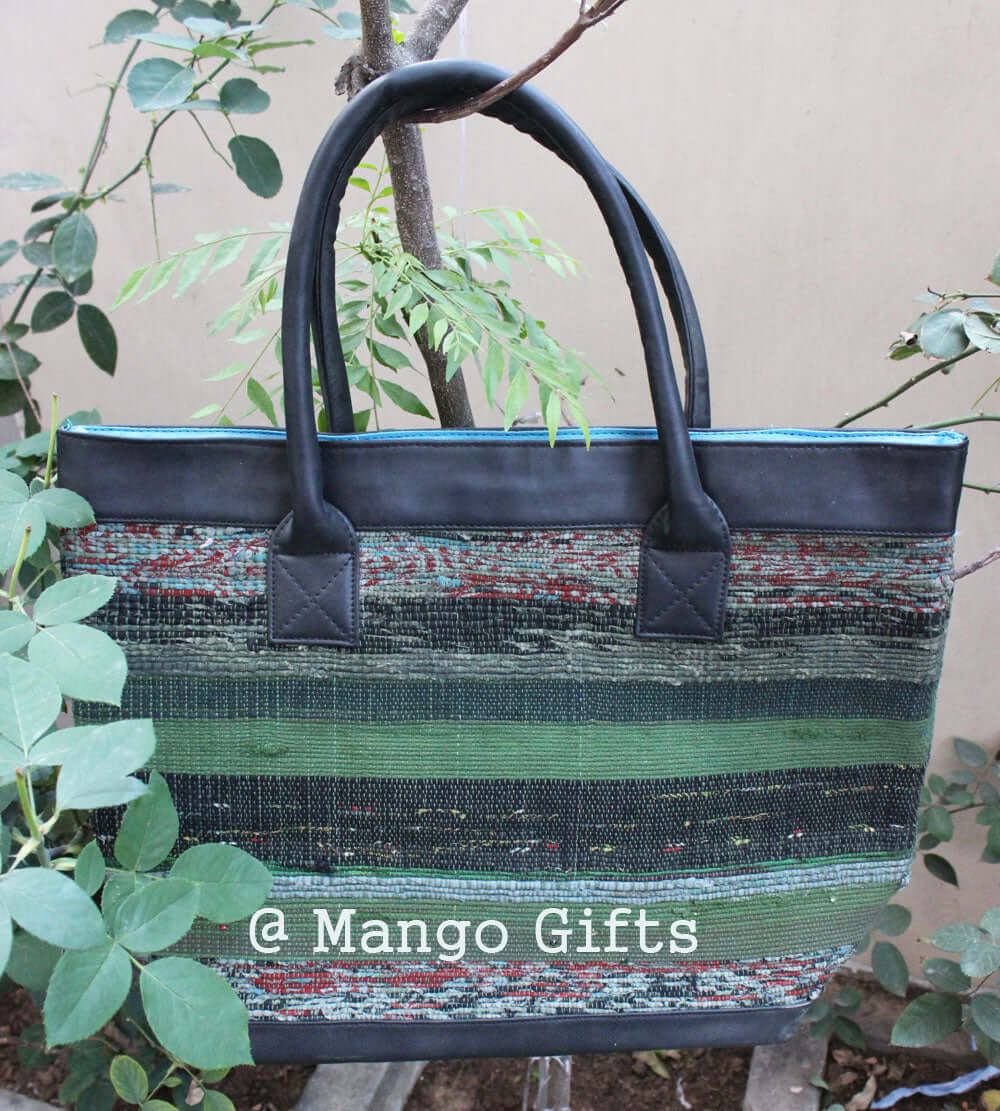 Stylish green cotton Kantha tote bag with leather straps, perfect for shopping or picnics, handmade in India.
