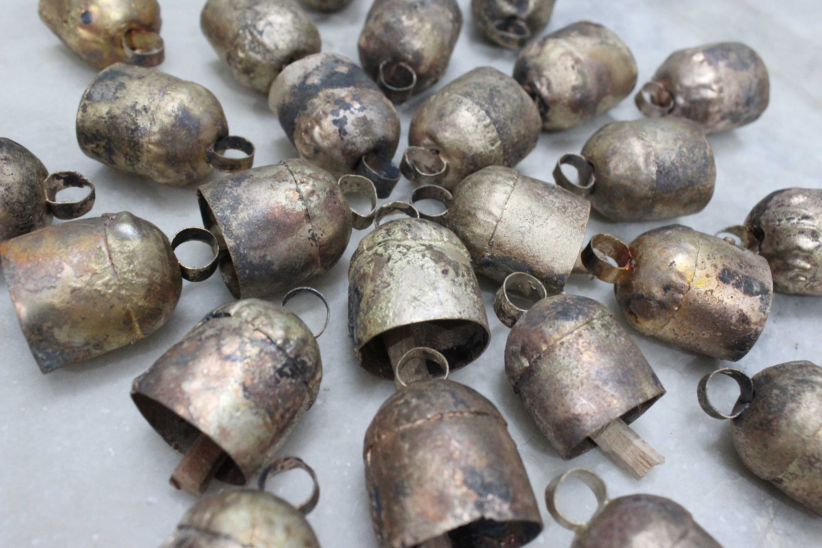 Explore our unique 2" rustic tin bells made from recycled iron with a vintage finish. Perfect for DIY projects and wall hanging decor!