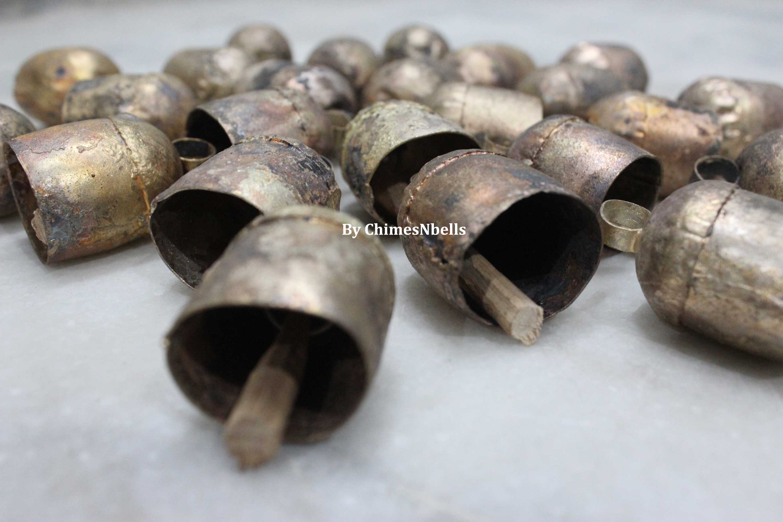 Explore our unique 2" rustic tin bells made from recycled iron with a vintage finish. Perfect for DIY projects and wall hanging decor!