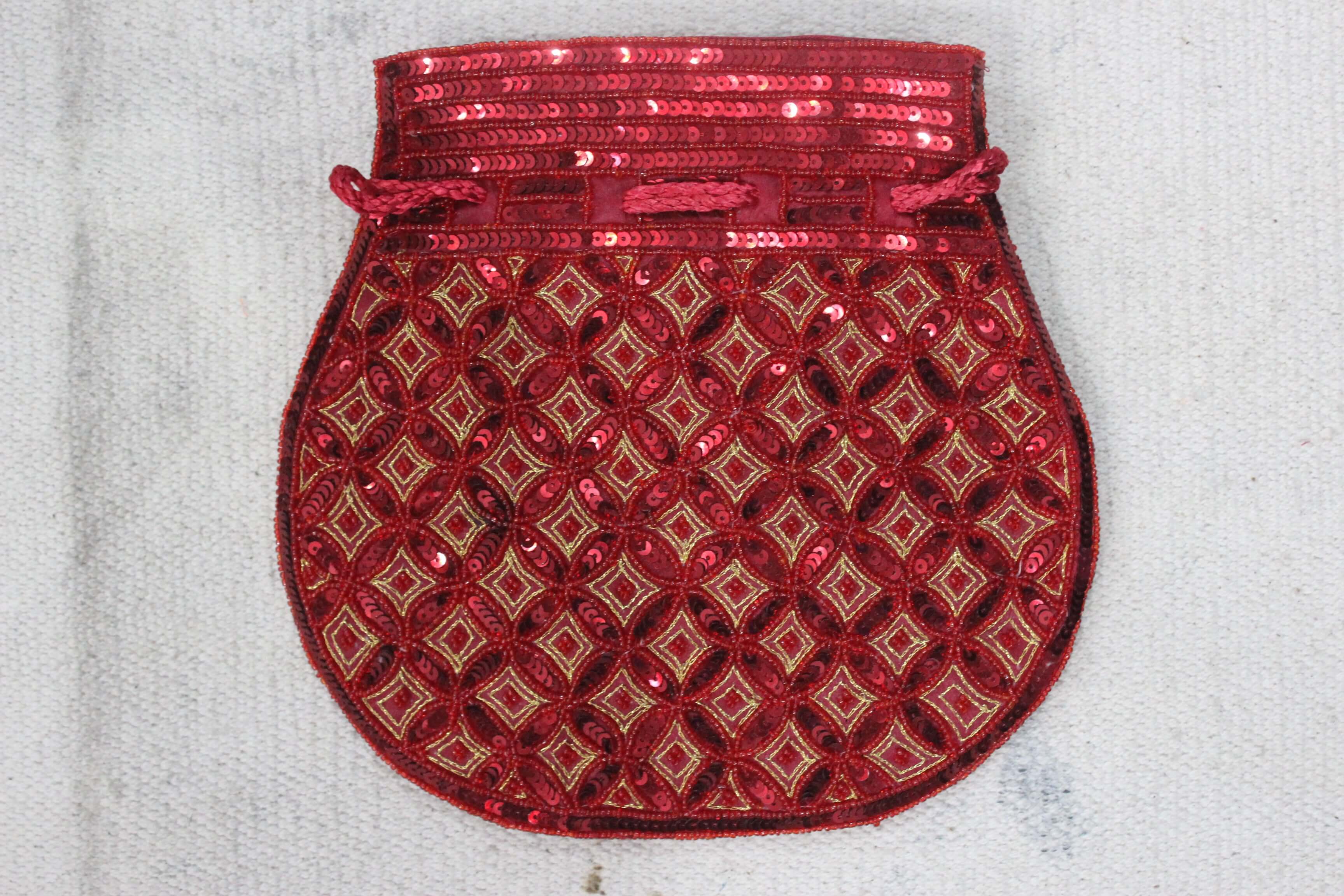Beautiful red handmade Indian potli bag with sequins, perfect for a stylish touch and carrying small essentials.