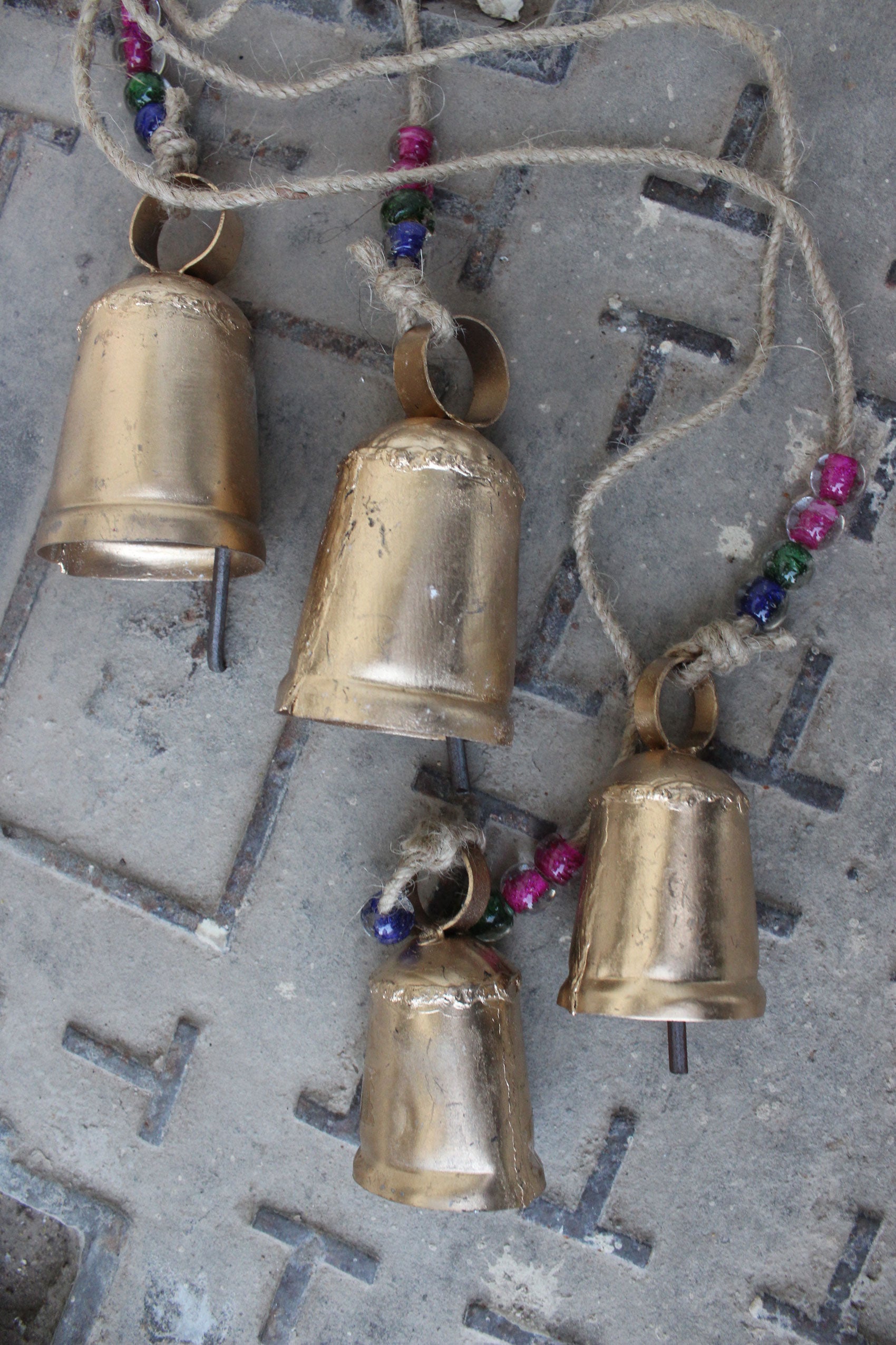 Handmade iron tin bells with jute string and glass beads, perfect for outdoor patio and garden decoration.
