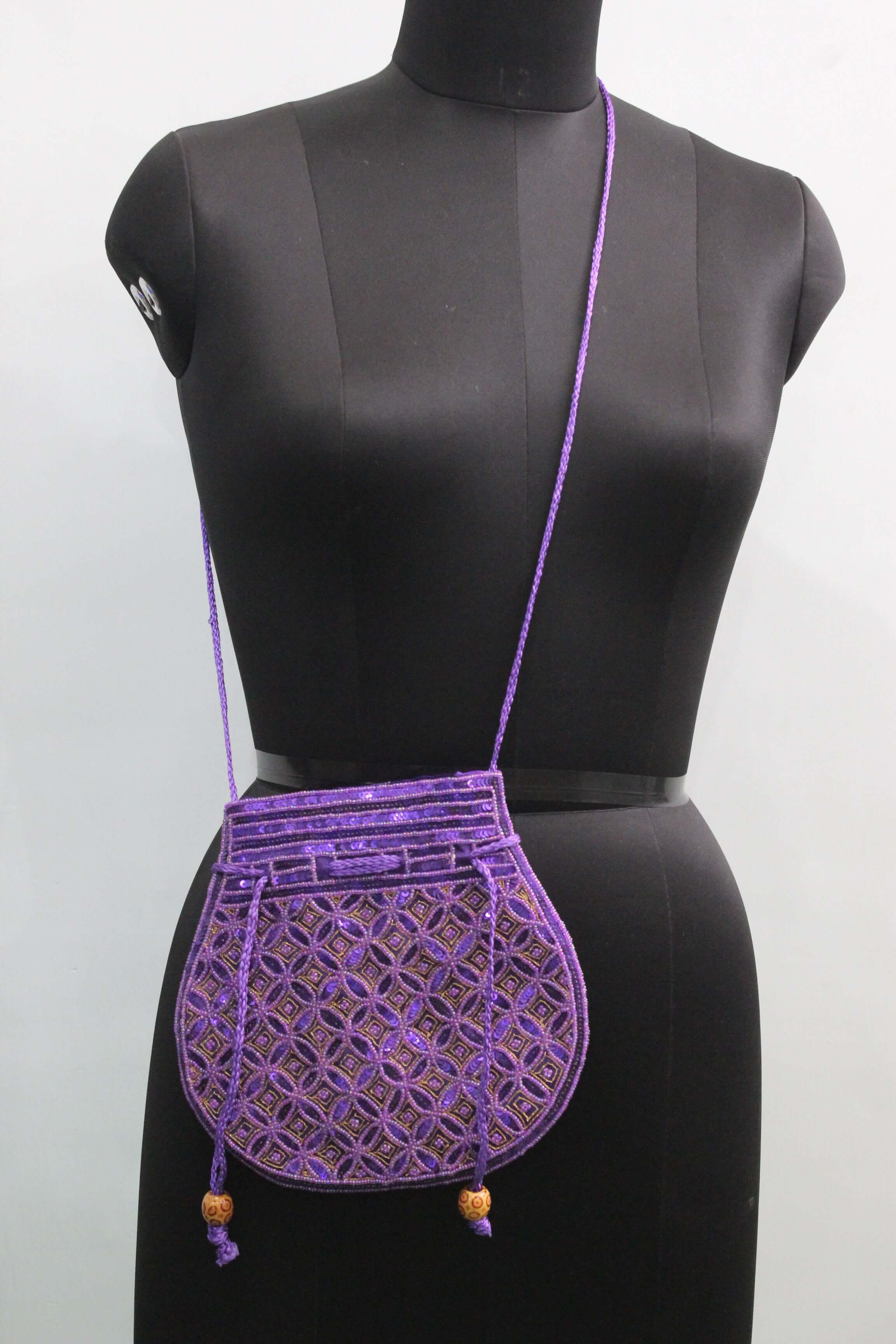 Handmade purple potli bag with sequins, showcasing a stylish sling design, perfect for carrying small essentials.