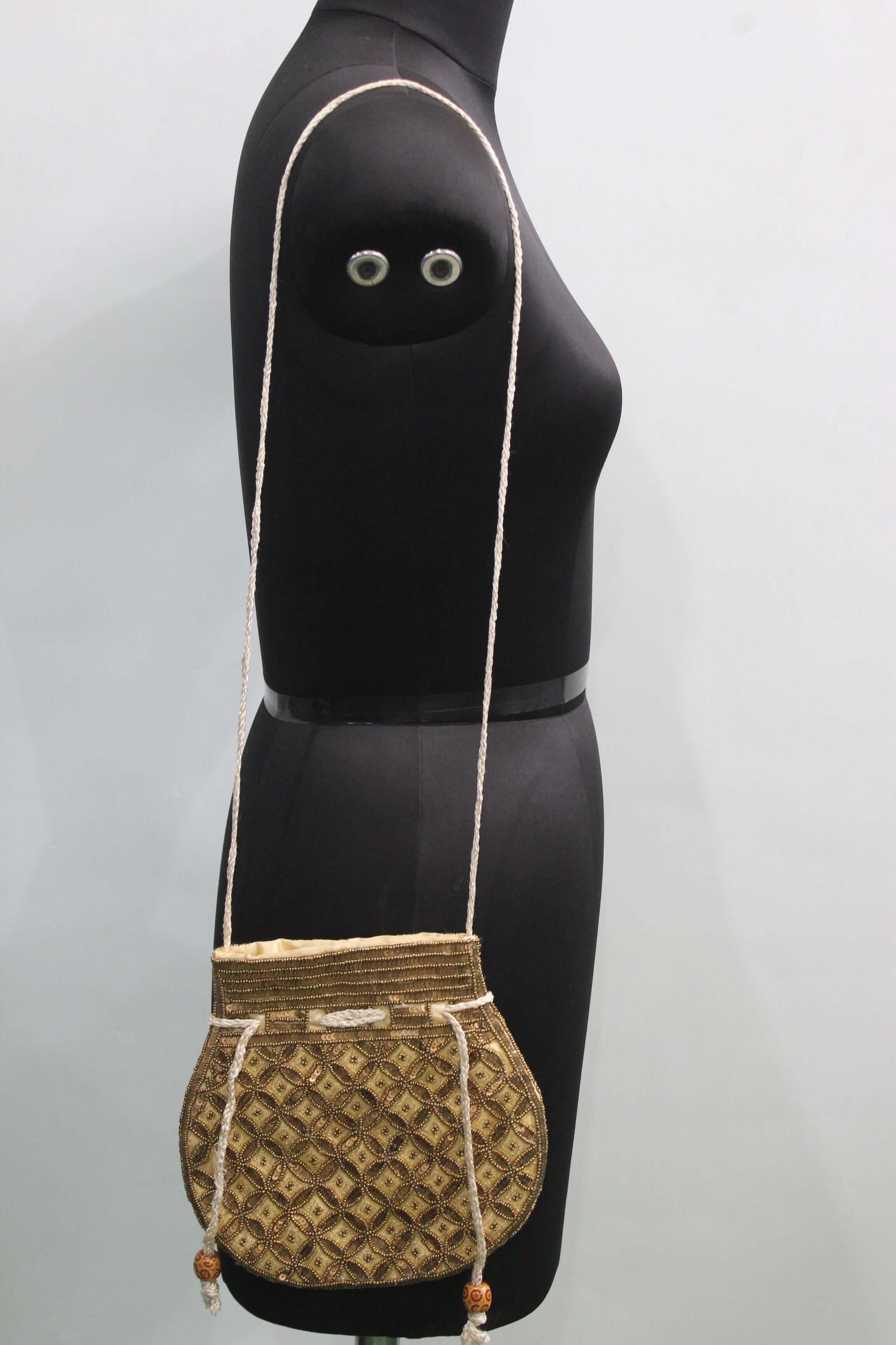 Olive golden handmade Indian potli bag with sequins, stylish sling bag for fashion enthusiasts.