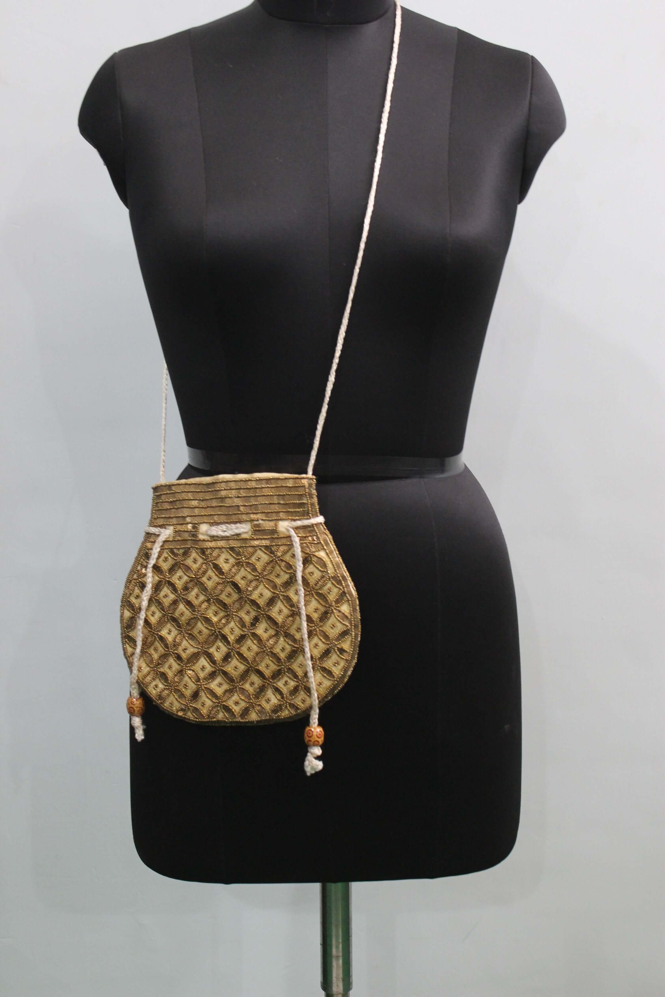 Beautiful olive golden handmade Indian potli bag with sequins, stylish and versatile for fashion use.