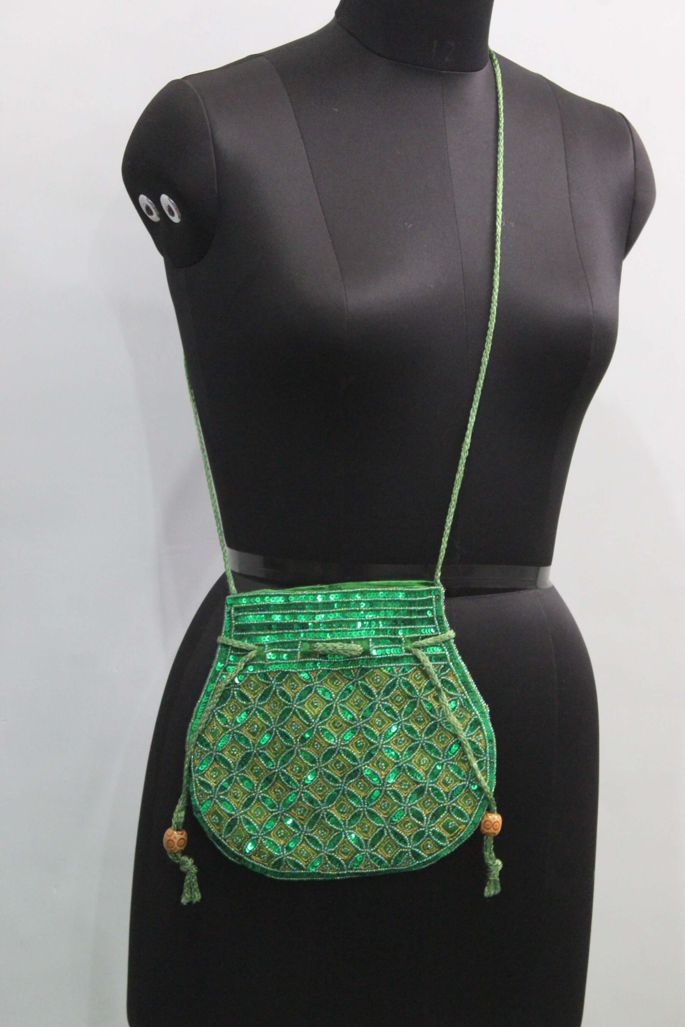 Beautiful green handmade Indian potli bag with sequins, perfect for fashion and small articles, featuring sling strap.