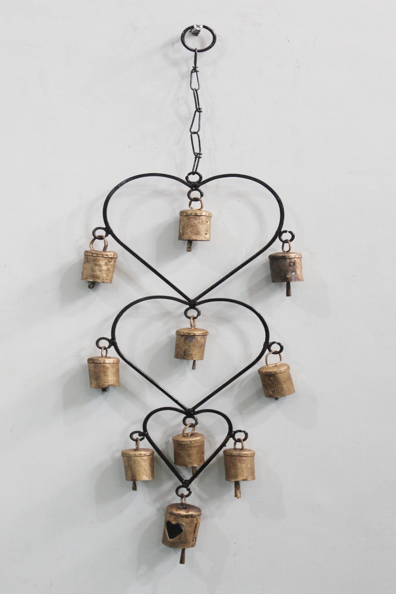 Beautiful handcrafted wind chime made from recycled iron, featuring gold bells. Perfect for home décor or as a thoughtful gift.