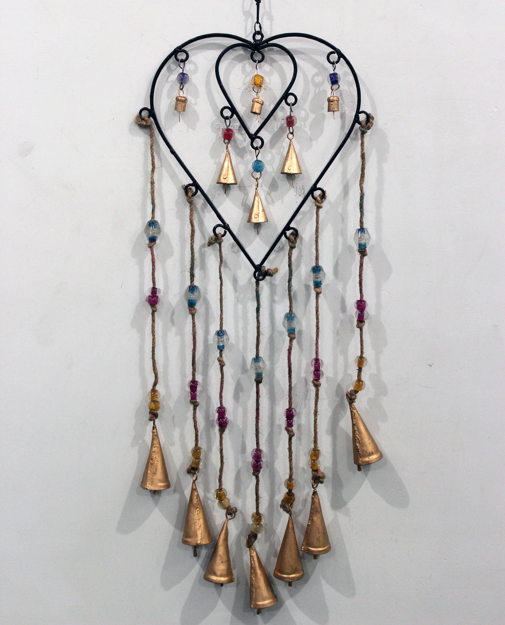 Charming recycled iron heart wind chime with colorful glass beads. Perfect for gifts or adding a loving touch to your patio.