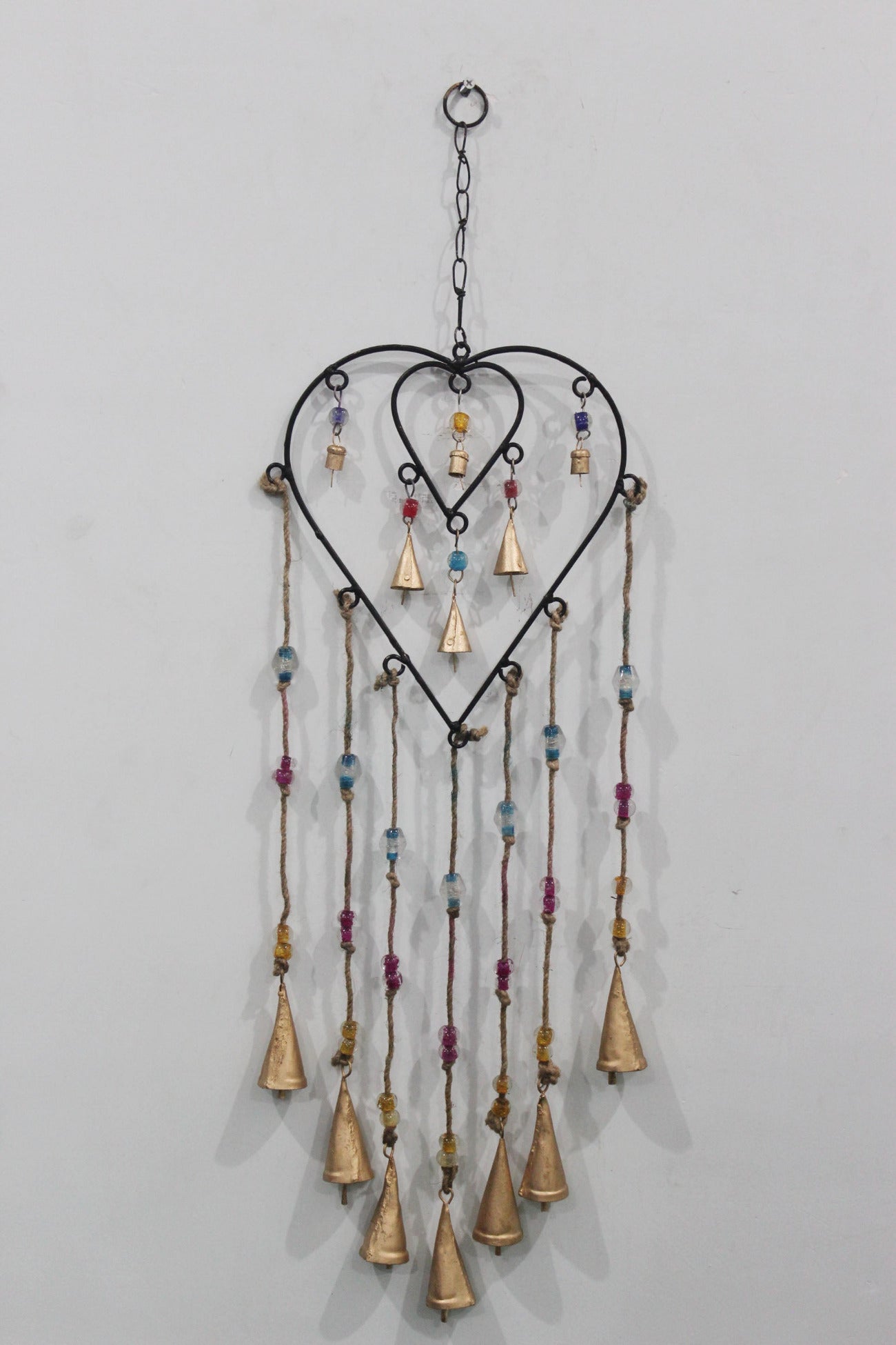 Charming recycled iron heart wind chime with colorful glass beads. Perfect for gifts or adding a loving touch to your patio.