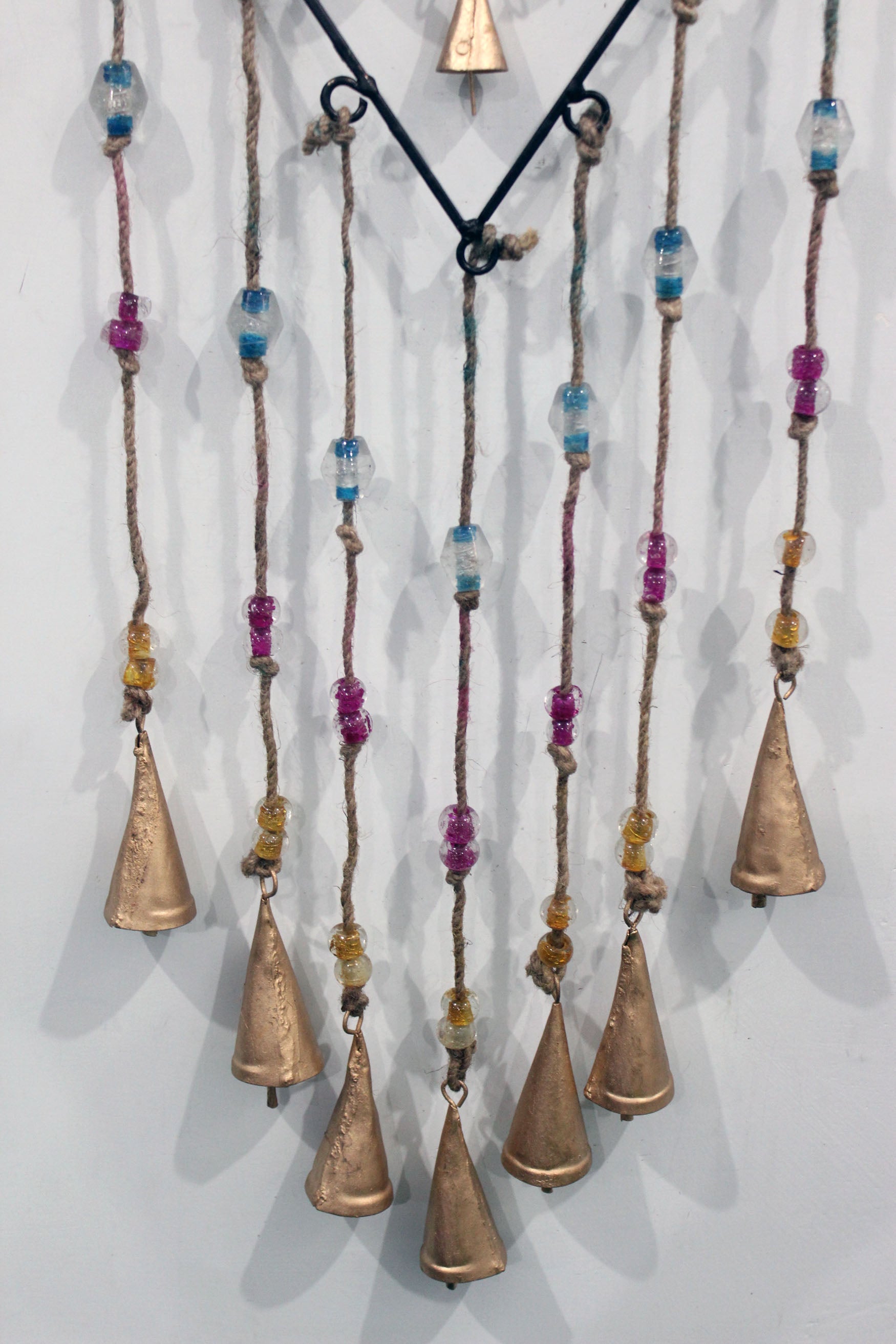 Charming recycled iron heart wind chime with colorful glass beads. Perfect for gifts or adding a loving touch to your patio.