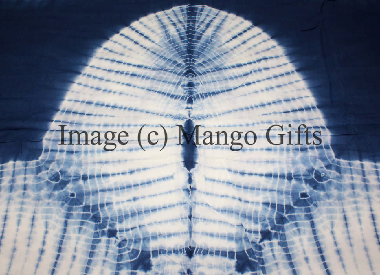 Close-up of blue tie dye pattern on a cotton quilt, showcasing vibrant designs for a queen size bed.