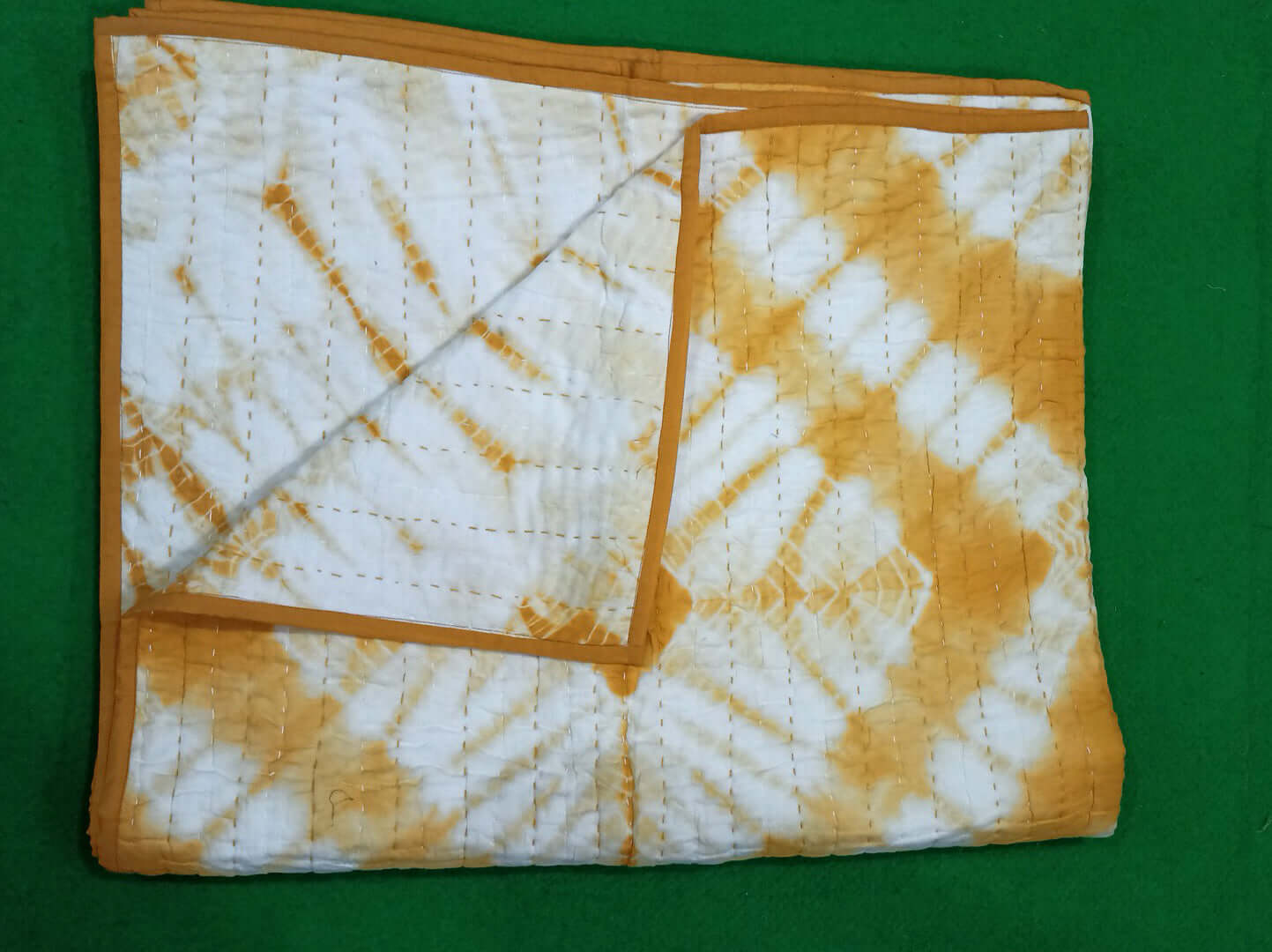 Cotton tie dye thin quilt in yellow and white, perfect for queen or twin size beds, soft and vibrant throw blanket.