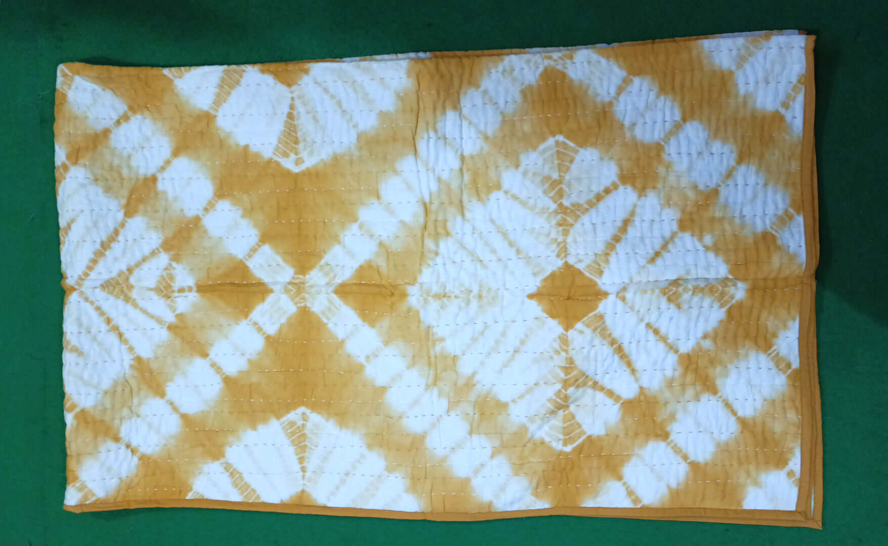 Cotton tie dye quilt in yellow with vibrant patterns, perfect for queen or twin beds and sofa throws.