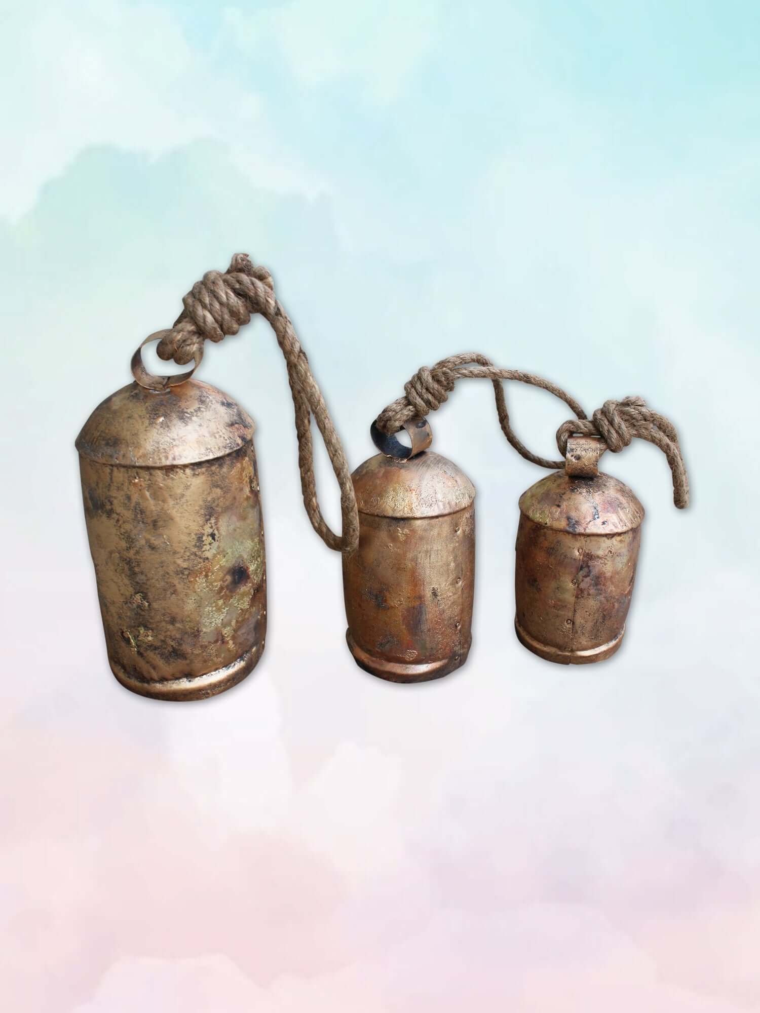 Set of 3 rustic iron cow bells with antique finish and wooden clappers, ideal for garden decoration.