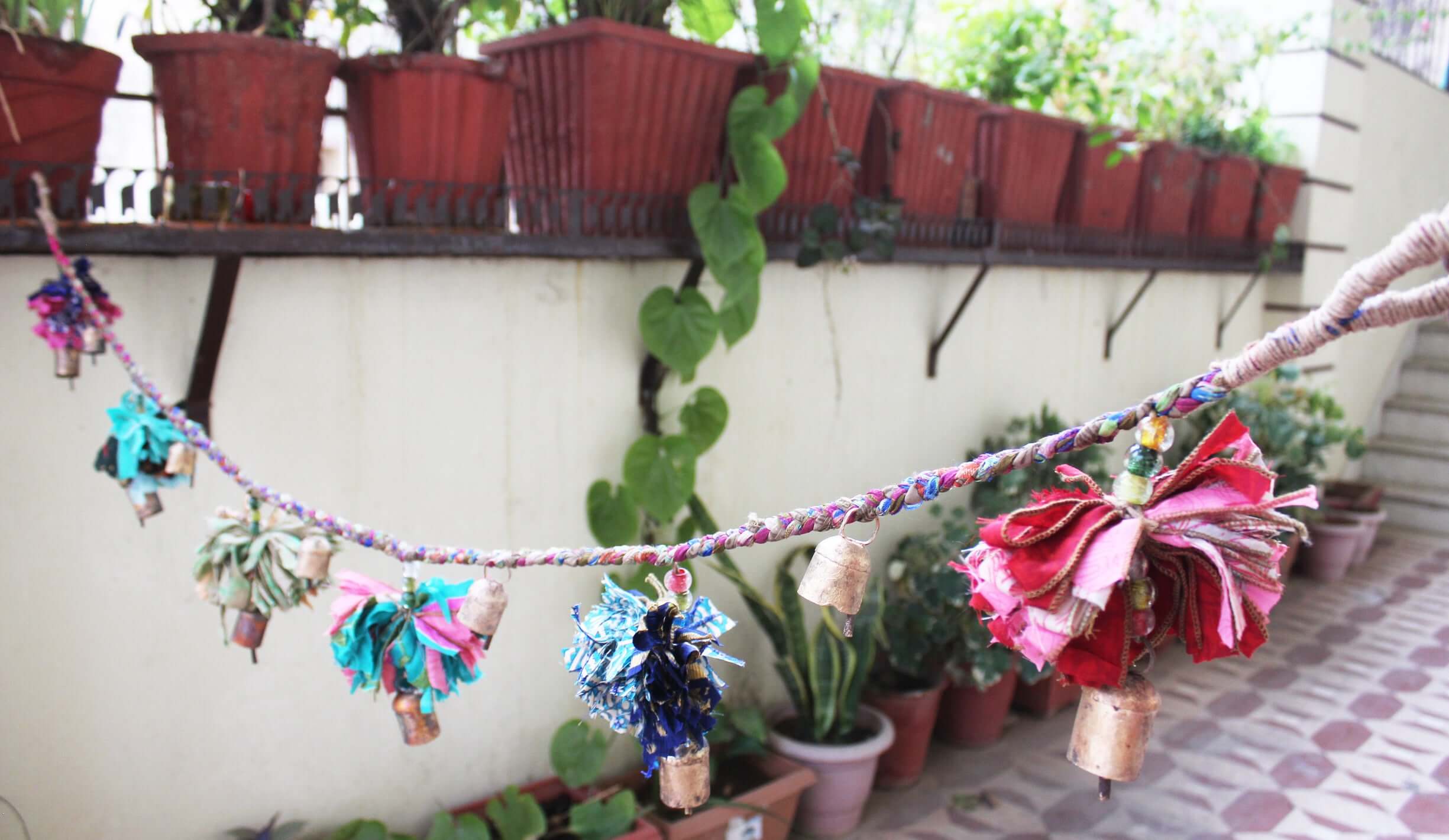 Adorn your space with this 5ft handmade garland of brass bells and glass beads. Perfect for parties and home decoration.