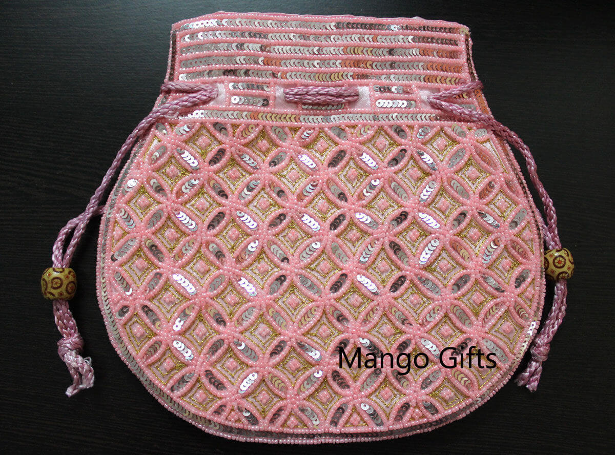 Beautiful pink handmade sequin potli bag with intricate designs and drawstring closure.